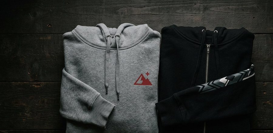 Custom printed hoodies — gray pullover and black zip-up with red vinyl logos